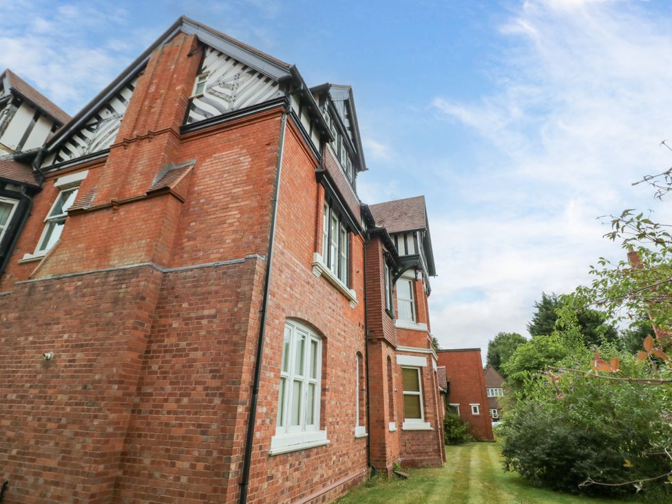 Exterior of a brick house with windows and garden at Manor House Birmingham