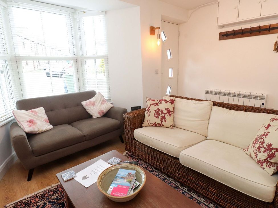 A living room with a couch and coffee table at Bodefi in Pwllheli