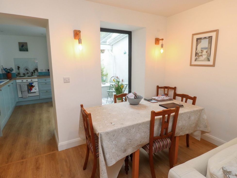 A dining room with a table and chairs at Bodefi in Pwllheli