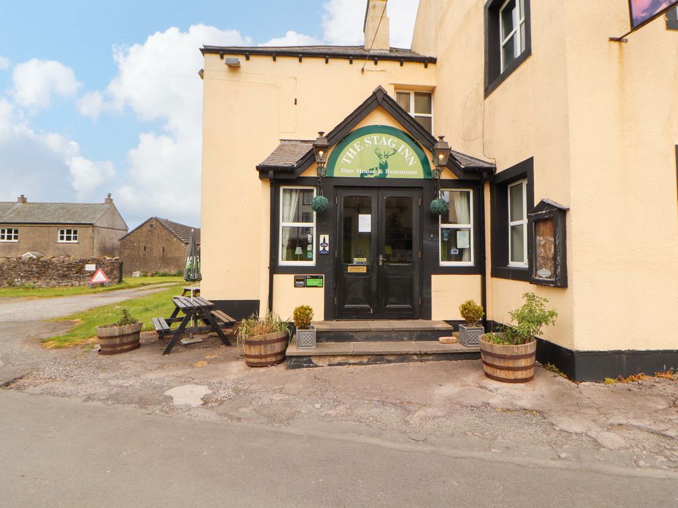 The entrance of The Stag Inn with planters and a sign at The Loft Apartment @ The Stag Inn Maryport