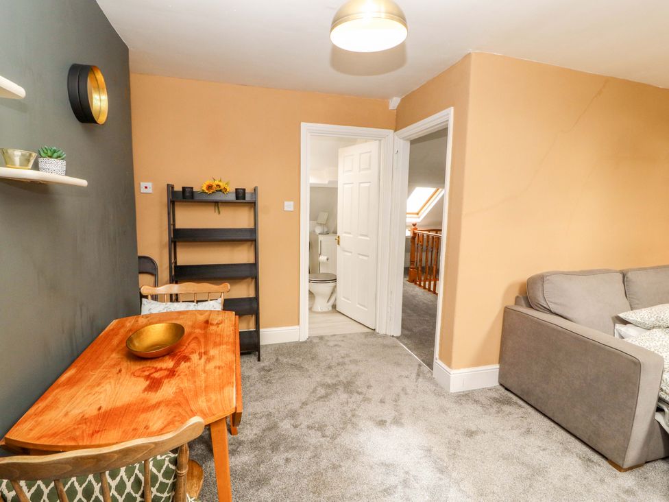 A living room with a table and chairs at The Loft Apartment @ The Stag Inn in Maryport