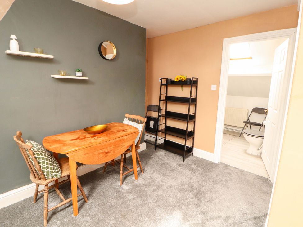 A dining room with a table and chairs at The Loft Apartment @ The Stag Inn in Maryport