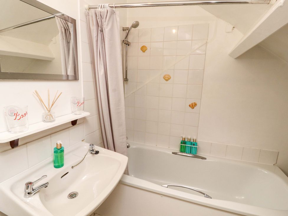 A bathroom with a bathtub, sink, and shower at The Loft Apartment @ The Stag Inn Maryport