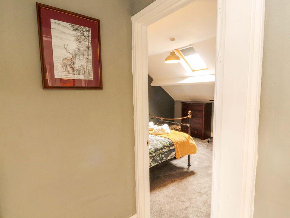 A bedroom with a bed and furniture at The Loft Apartment @ The Stag Inn, Maryport