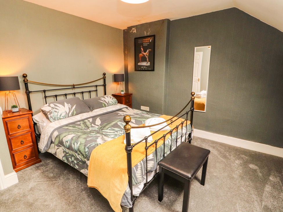 A bedroom with a bed and nightstands at The Loft Apartment @ The Stag Inn, Maryport