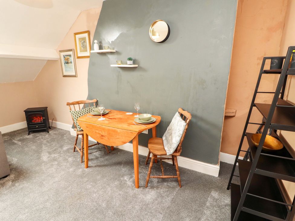 A dining area with a table and chairs at The Loft Apartment @ The Stag Inn Maryport