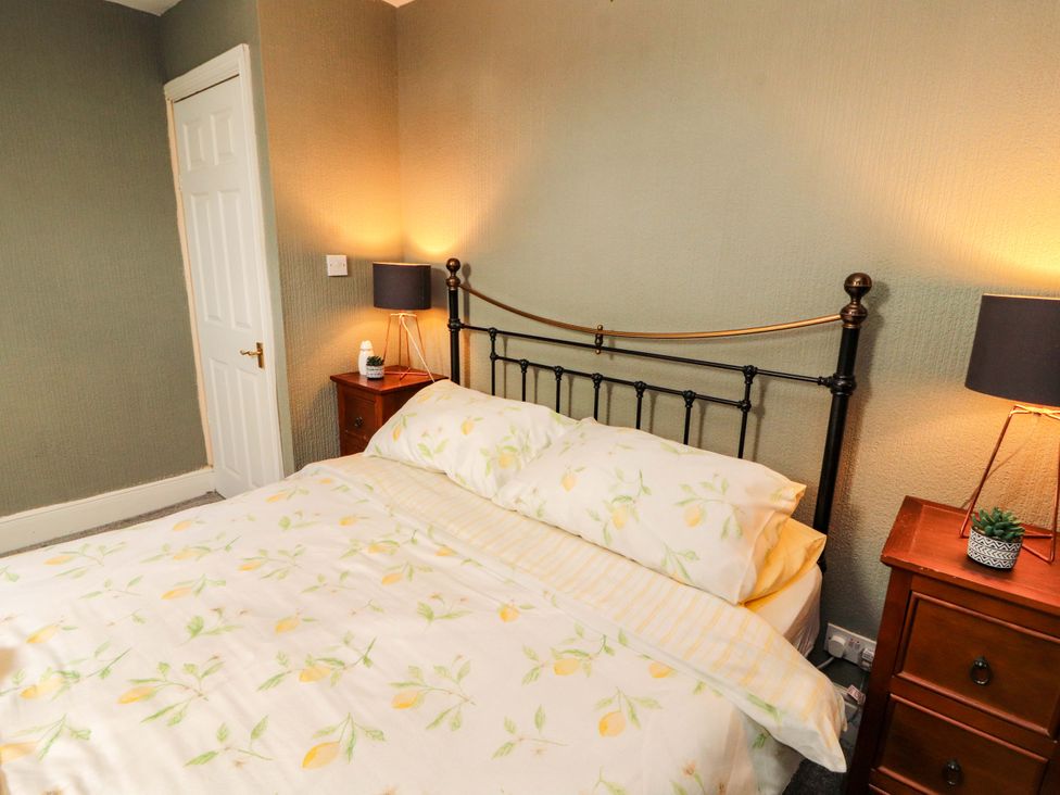 A bedroom with a bed and bedside tables at The Loft Apartment @ The Stag Inn, Maryport