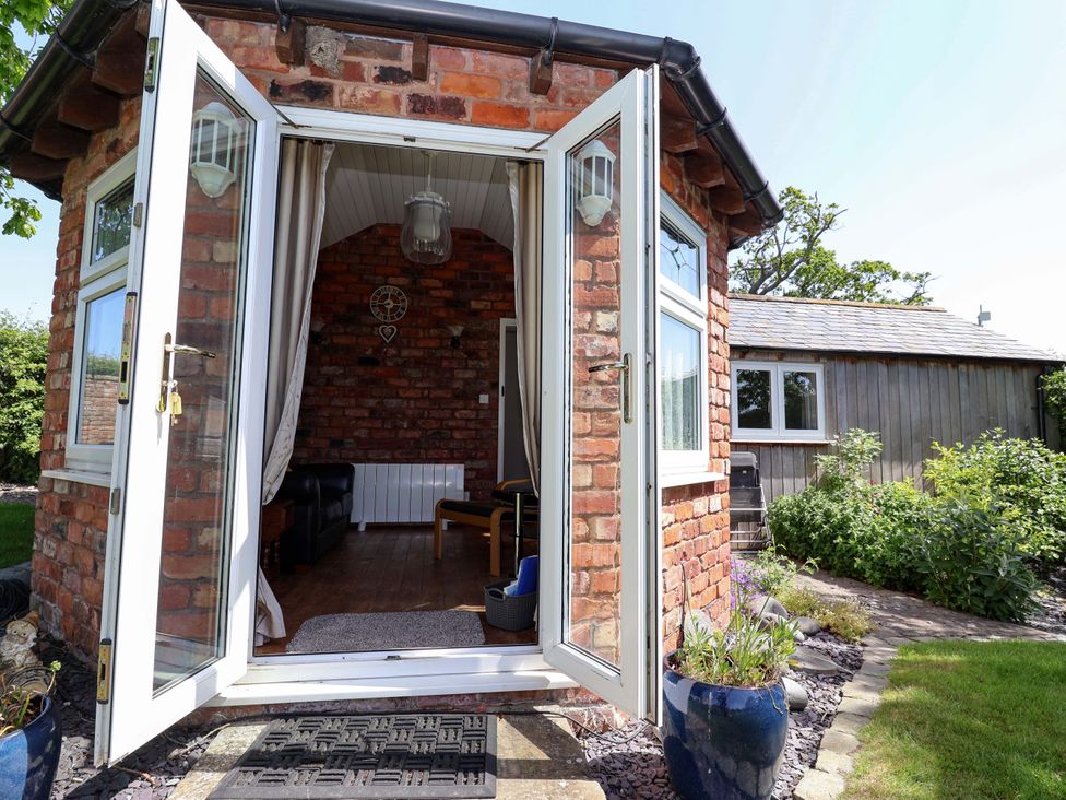 An outdoor photo of a room with a sofa and table at Ty Haf in Rhosemor