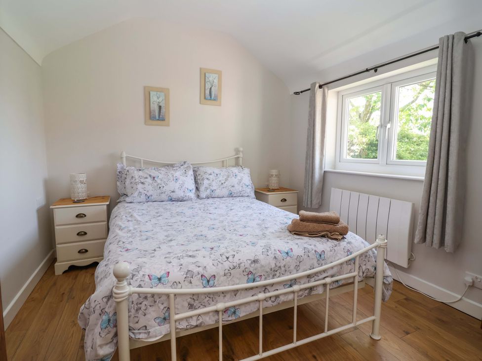 A bedroom with a bed and bedside table at Ty Haf in Rhosemor