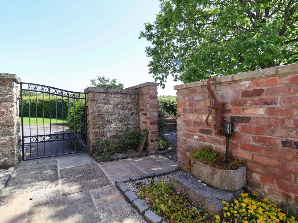 A garden gate and stone wall at Ty Haf in Rhosemor