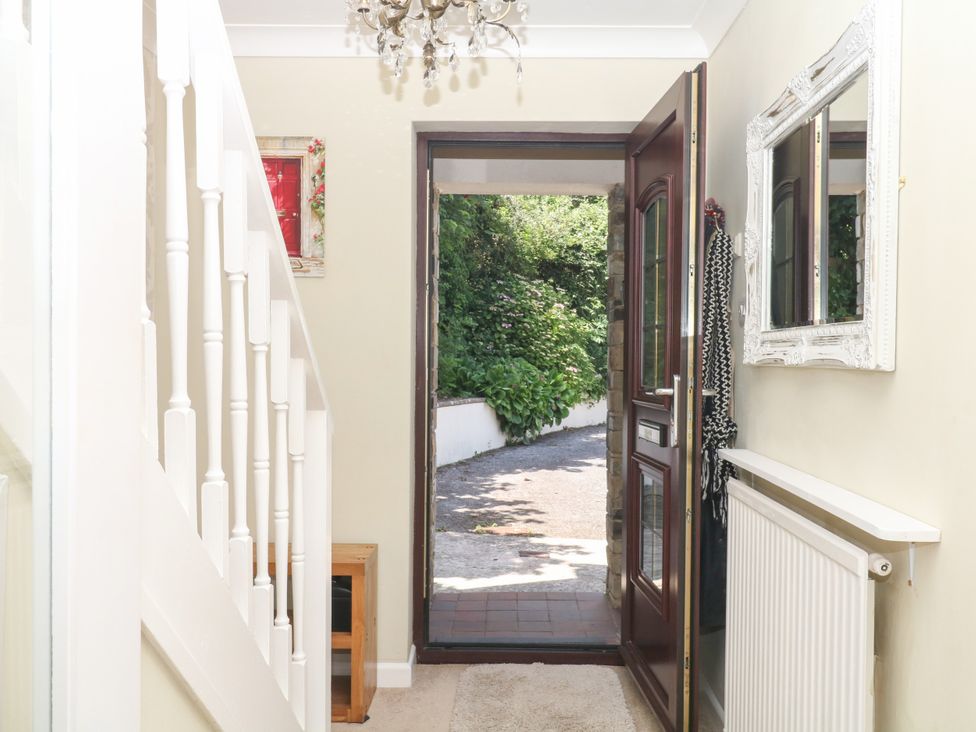 A hallway with a staircase and front door at Marldon Mews in Marldon