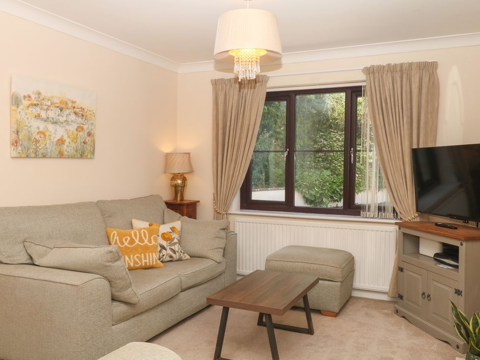 A living room with a sofa and table at Marldon Mews in Marldon