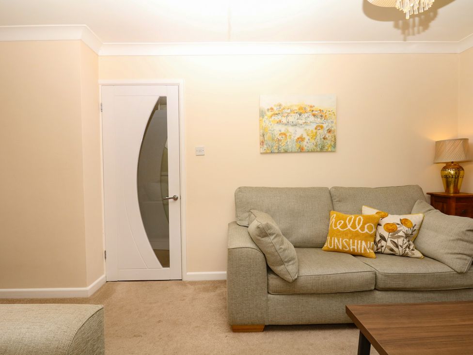 A living room with a sofa and lamp at Marldon Mews in Marldon