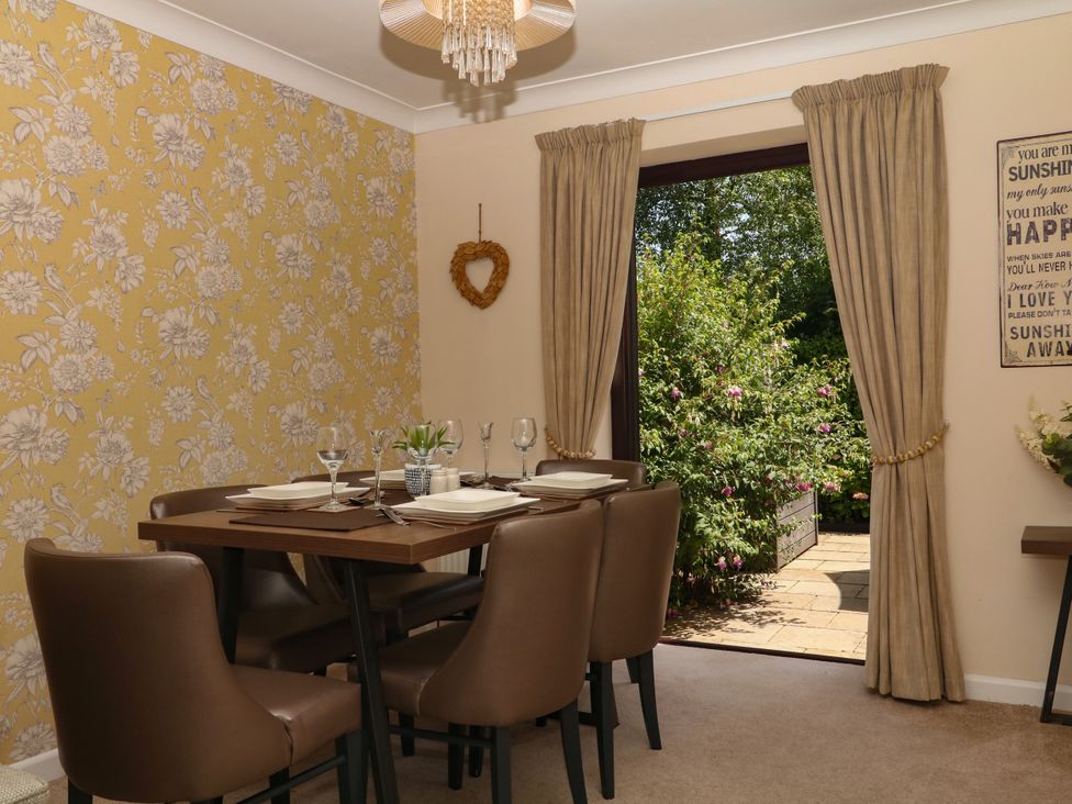 A dining room with table and chairs at Marldon Mews in Marldon