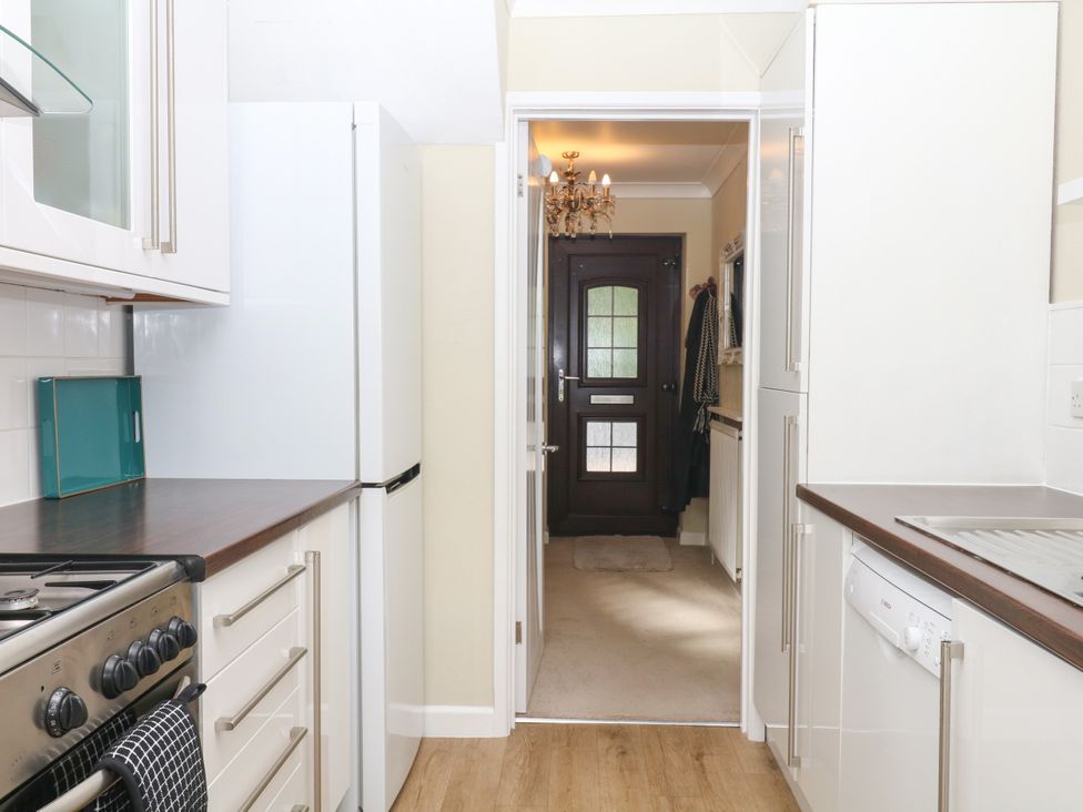 A kitchen with appliances and a door at Marldon Mews in Marldon