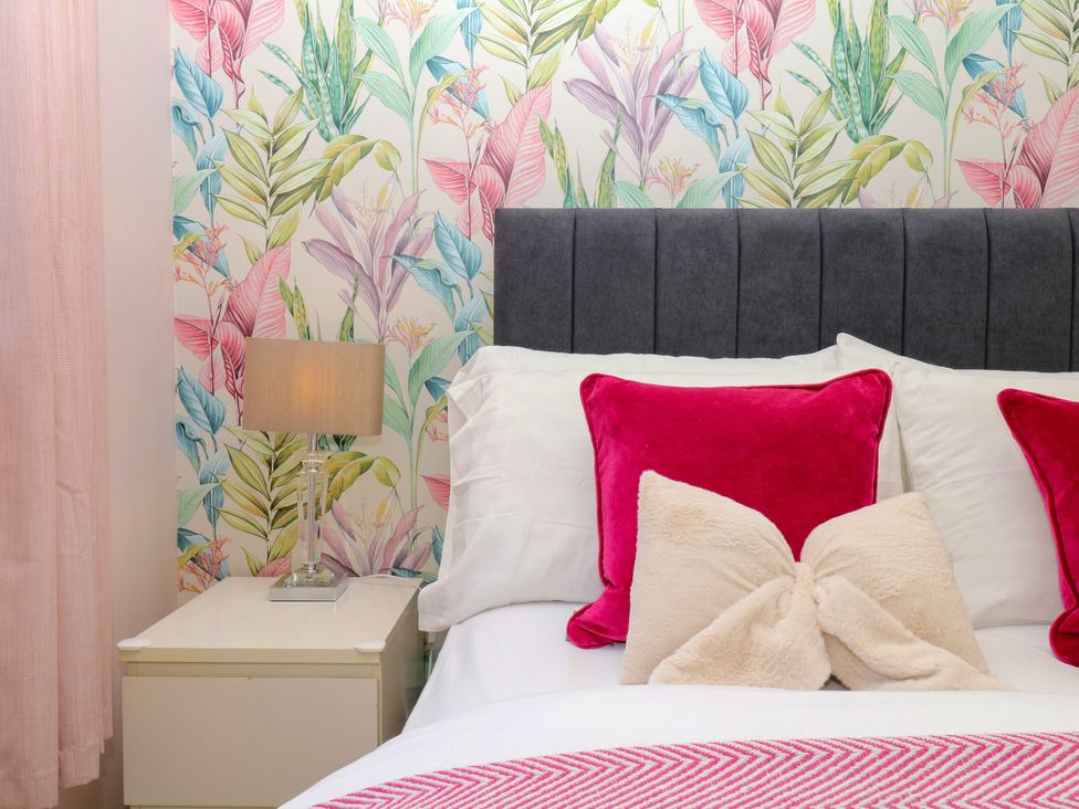 A bedroom with a bed and lamp at Marldon Mews in Marldon