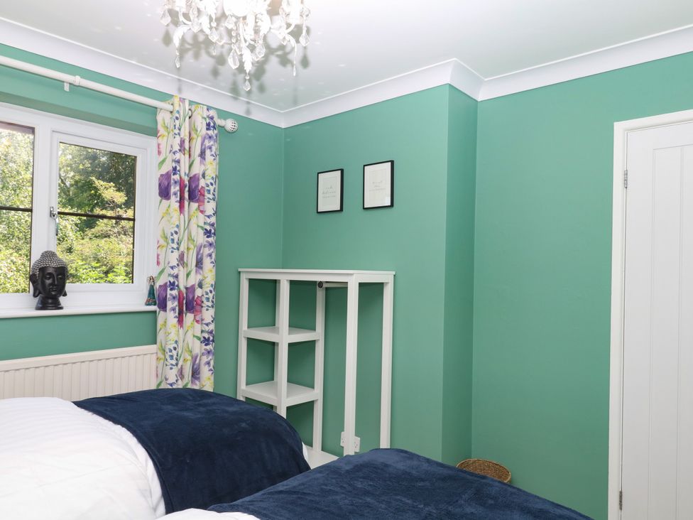 A bedroom with two beds and a window at Marldon Mews in Marldon