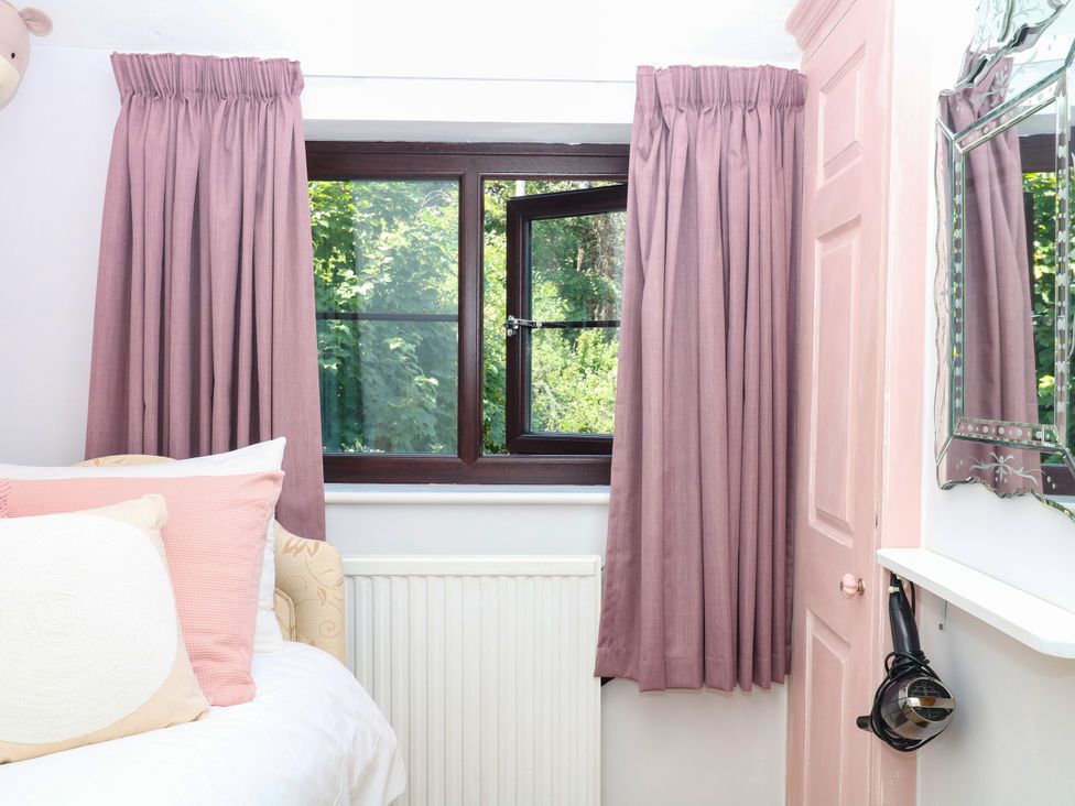 A bedroom with a bed and window at Marldon Mews in Marldon