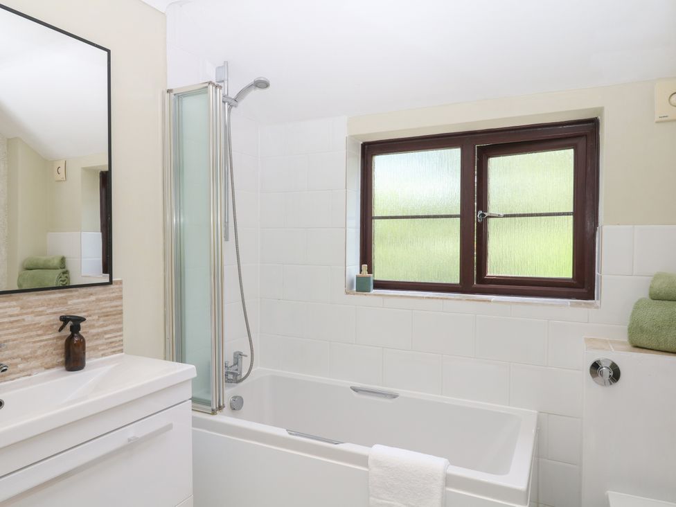 A bathroom with a bathtub and shower at Marldon Mews in Marldon