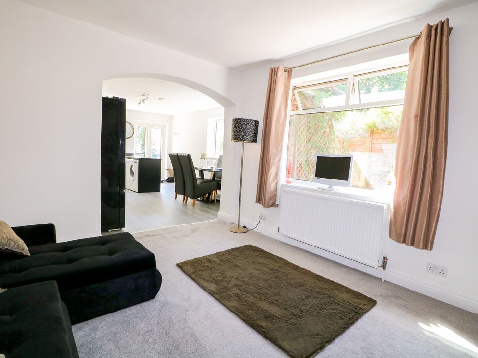 A living room with a sofa and television at Lucerne Cottage in Dorking