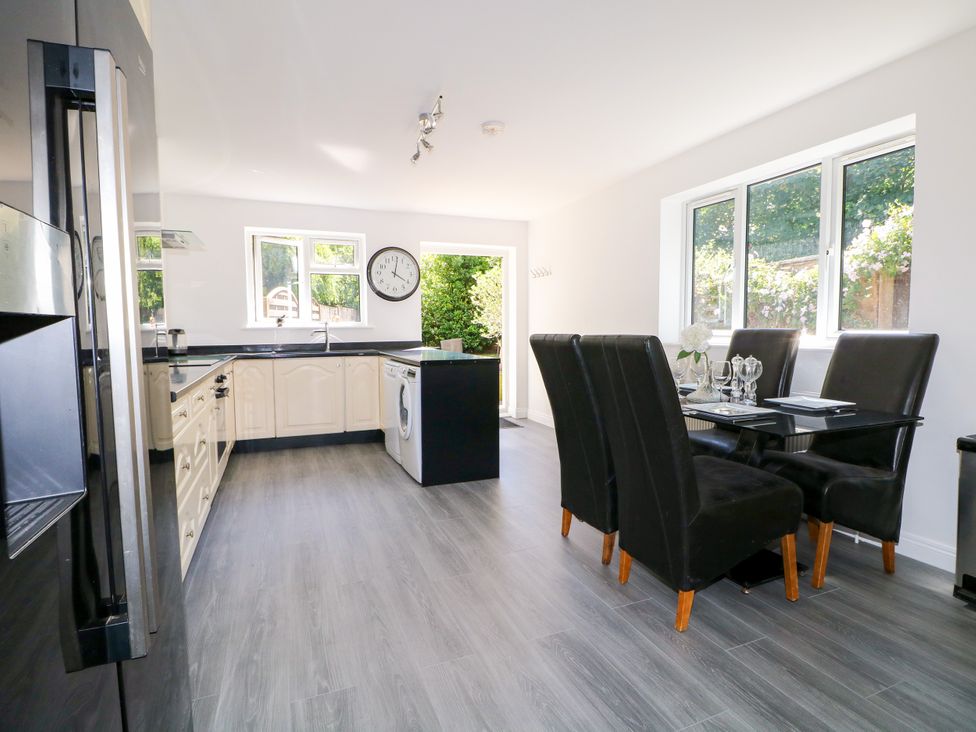 A kitchen with a dining table and chairs at Lucerne Cottage in Dorking