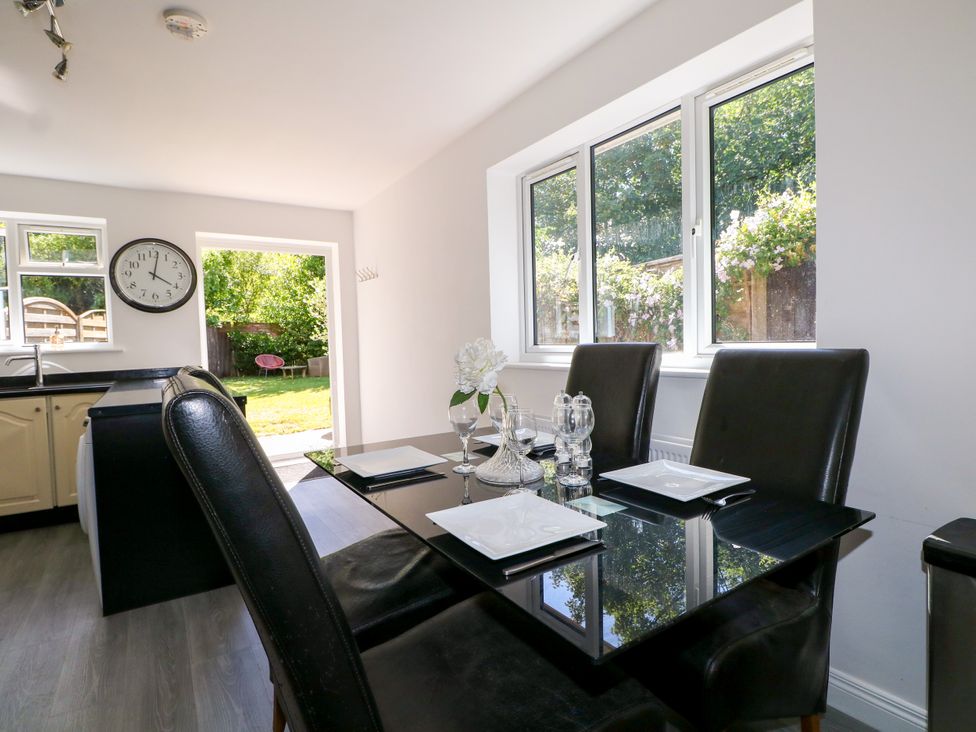 A dining room with a table and chairs at Lucerne Cottage in Dorking