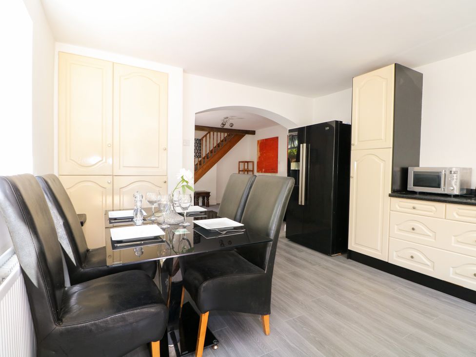 A kitchen with a dining table and chairs at Lucerne Cottage in Dorking