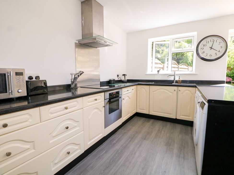 A kitchen with appliances and cabinets at Lucerne Cottage in Dorking