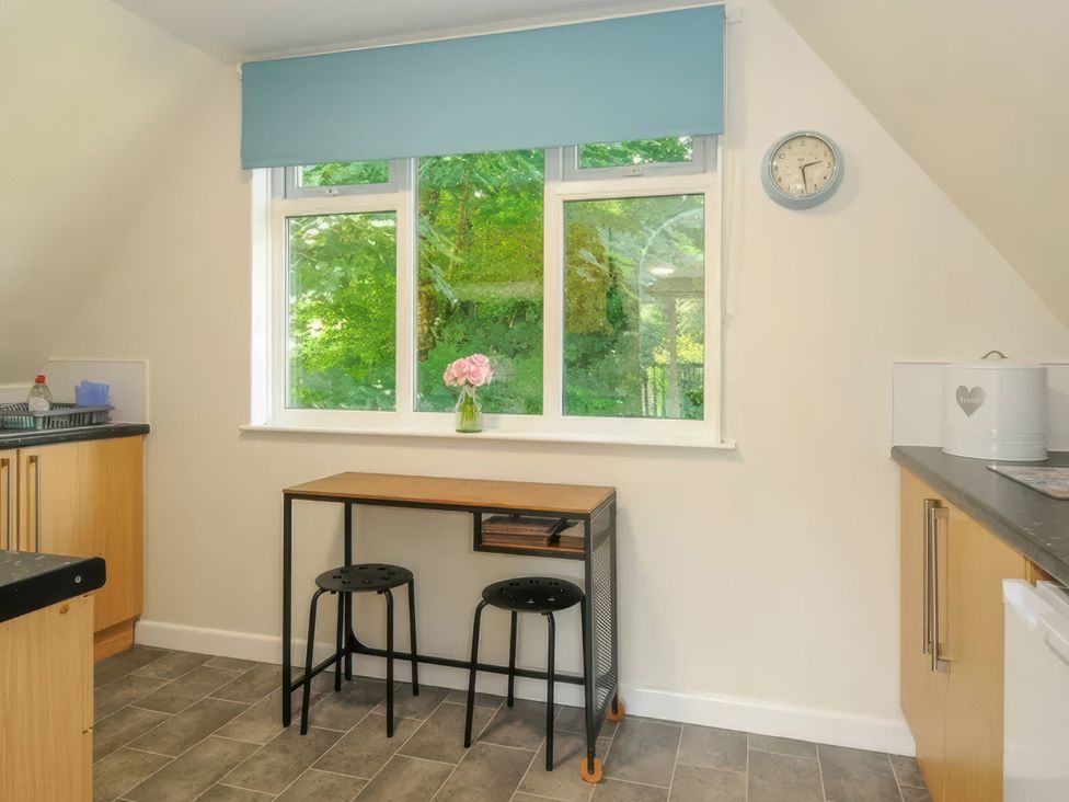 A kitchen with a table near a window at 9 Honicombe Park Callington