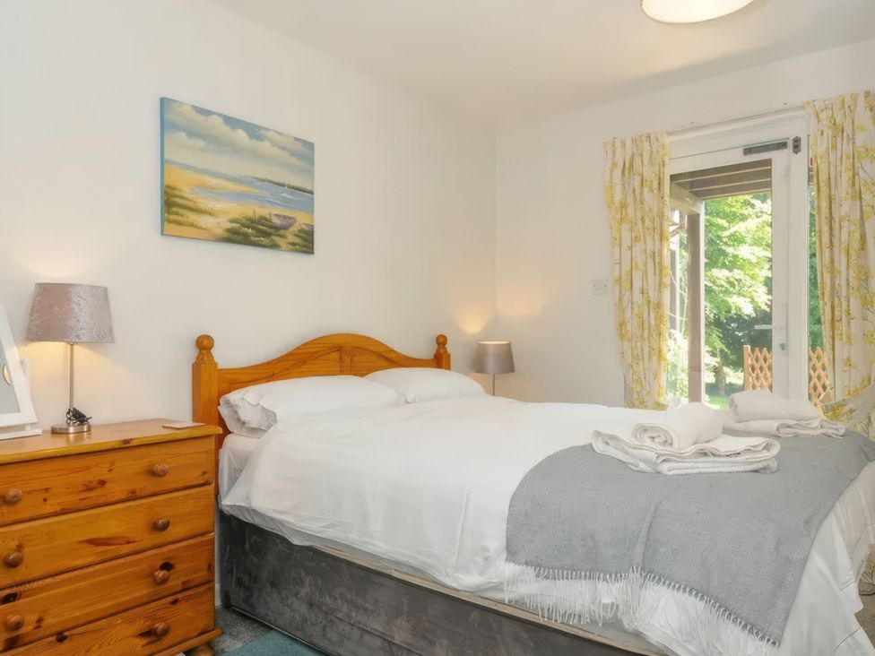 A bedroom with a bed and dresser at 9 Honicombe Park in Callington