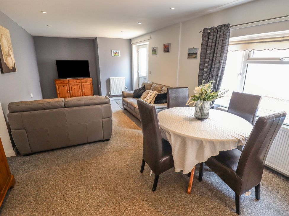 A living room with a sofa and dining table at Number 3 Old Boston Road Coningsby