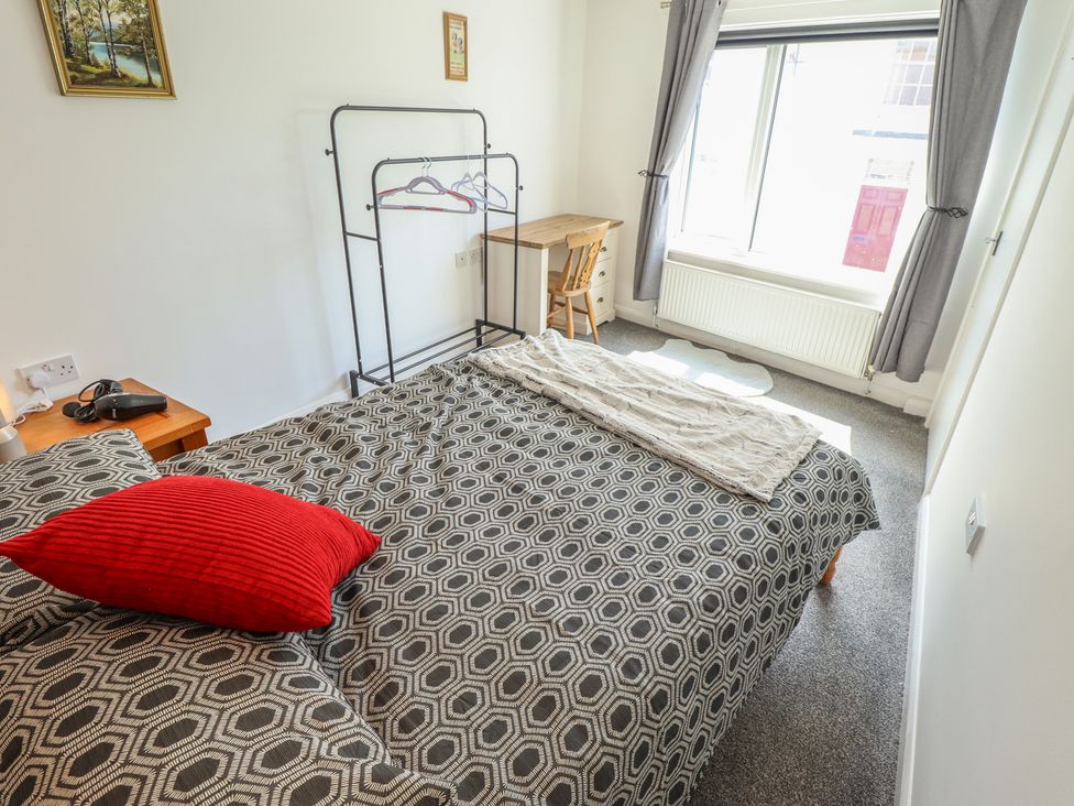 A bedroom with a bed and desk with a chair at Number 3 Old Boston Road Coningsby