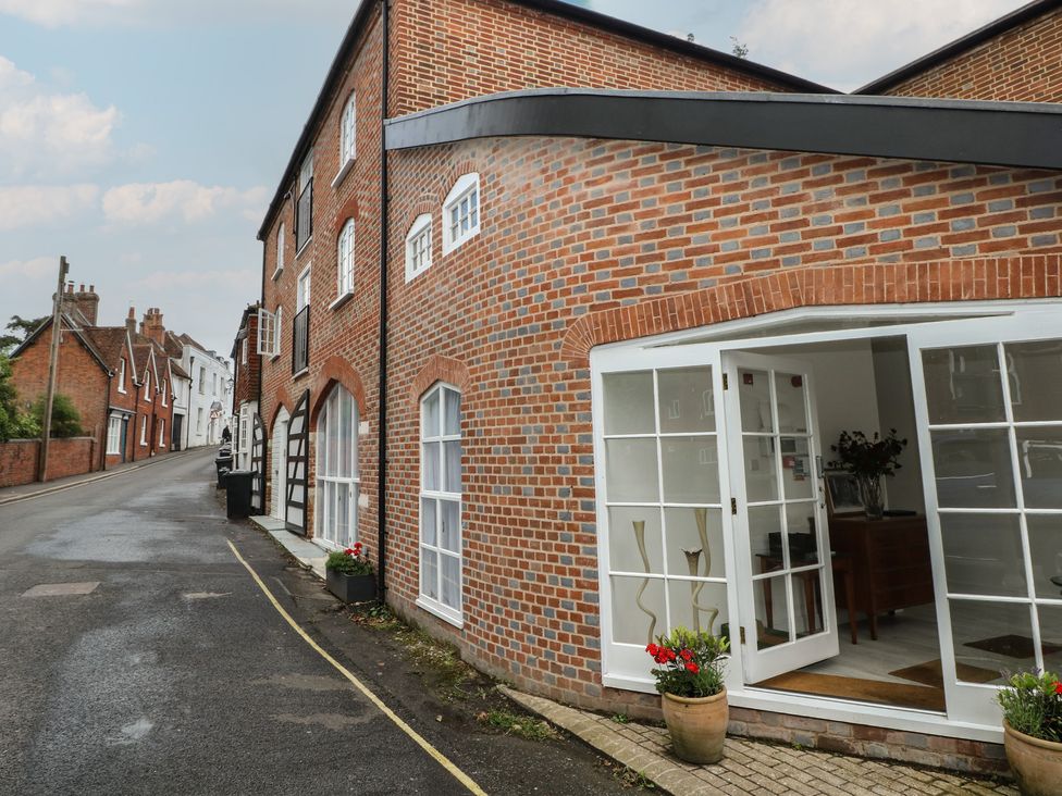 An outdoor view of a brick building with large windows at 1 Bed in Bishop's Waltham