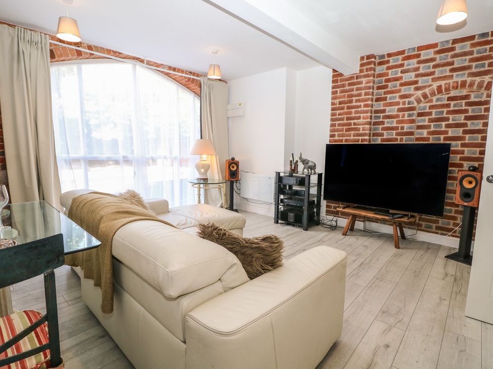 A living room with a sofa and TV at 1 Bed in Bishop's Waltham