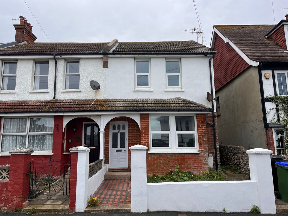A house with brick wall and windows at 5a Bramber Road Seaford
