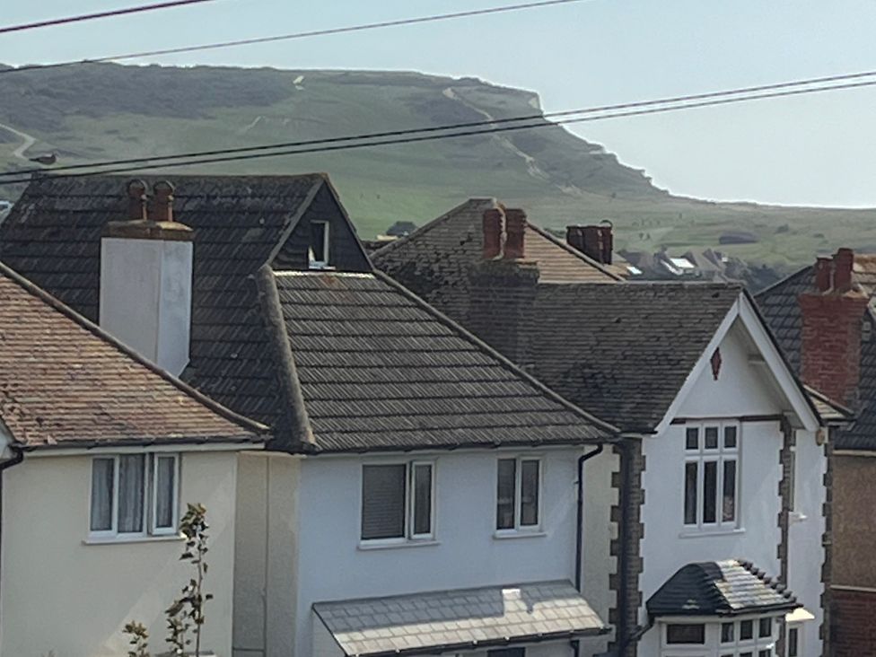 A view of rooftops and hills at 5a Bramber Road in Seaford