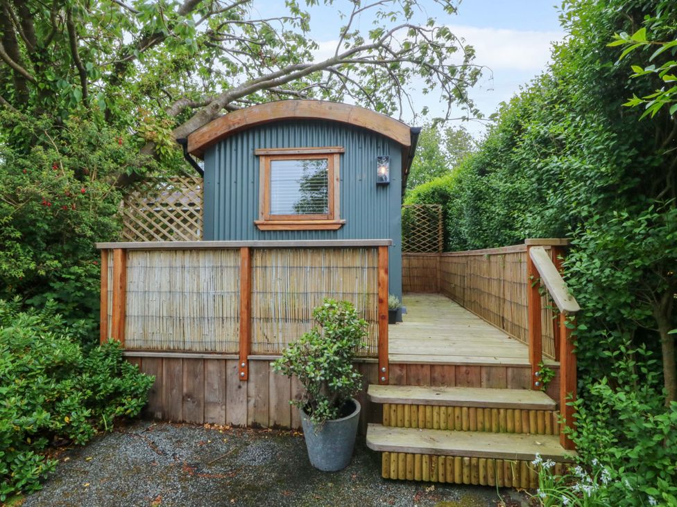 A garden with a wooden hut and steps at Ardwyn in Pwllheli