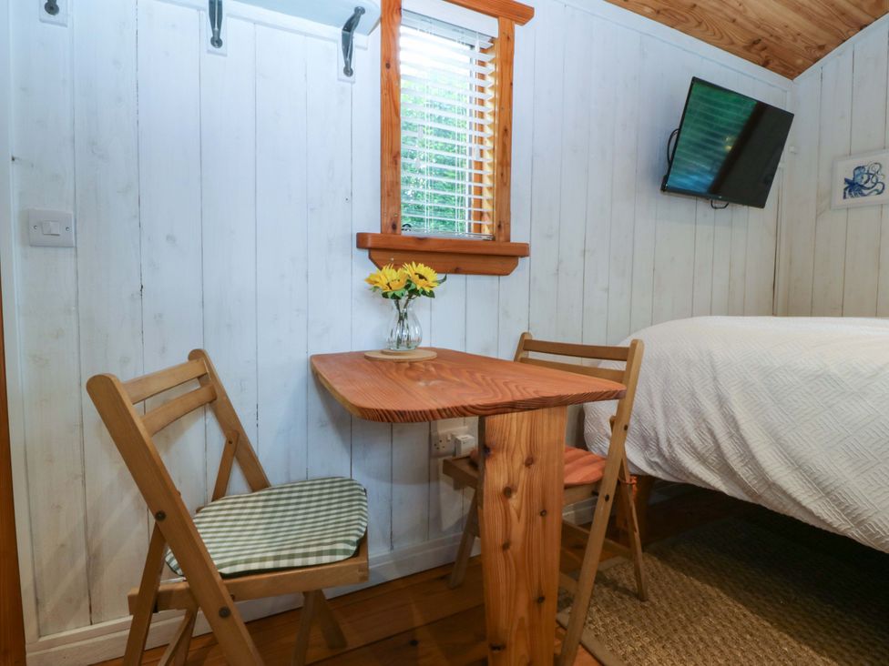 A bedroom with a table and chairs at Ardwyn in Pwllheli