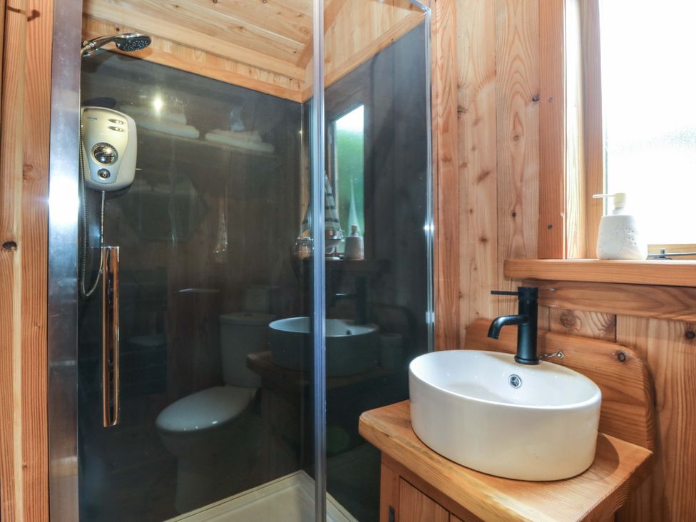 A bathroom with a shower, toilet, and sink at Ardwyn in Pwllheli