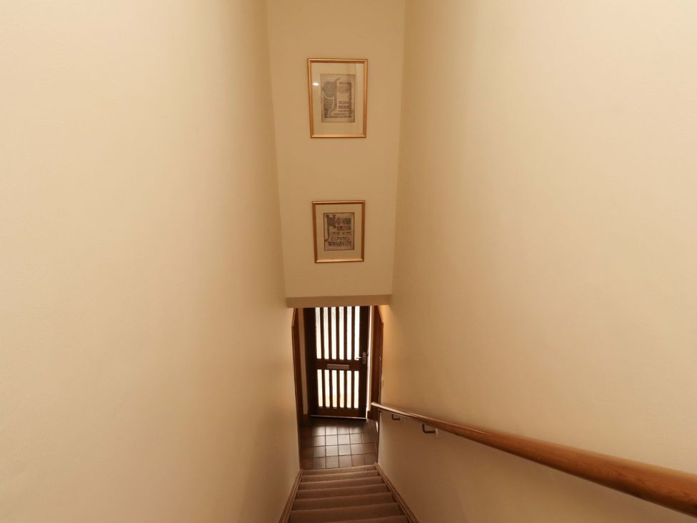 A staircase leading to a door at Sarah's Cottage