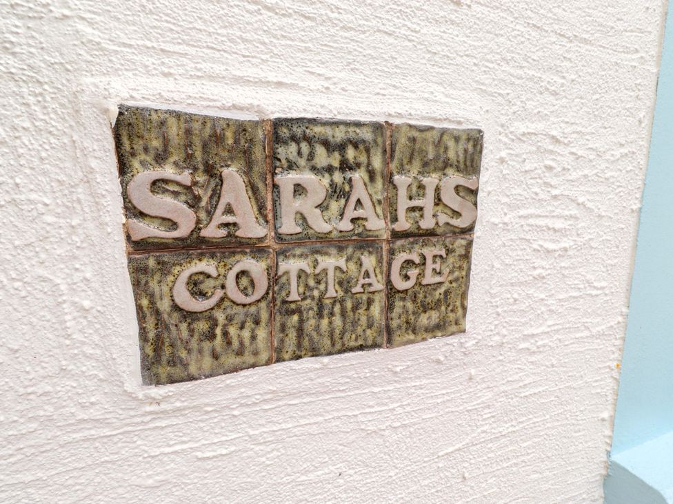 A sign on the wall displaying Sarah's Cottage