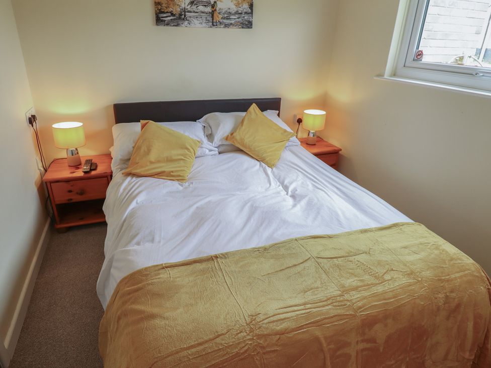 A bedroom with a bed and bedside tables at Cosy Home in Great Yarmouth