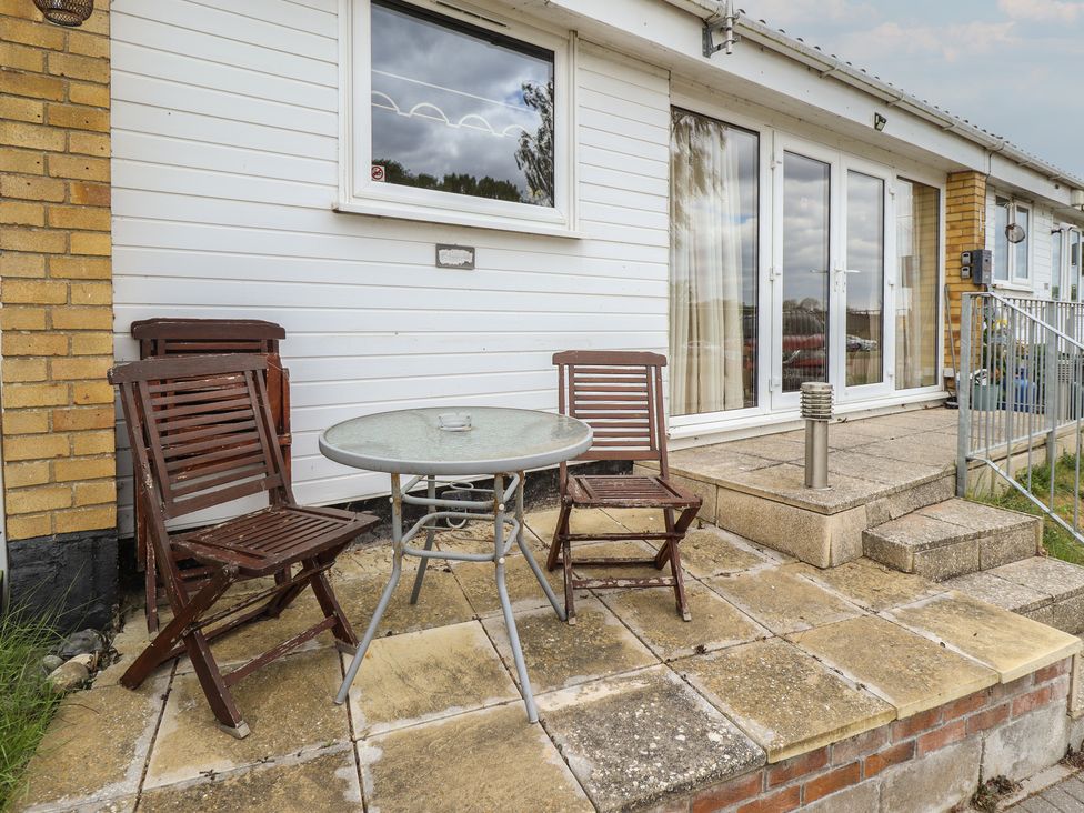 A patio with a table and chairs at Cosy Home in Great Yarmouth