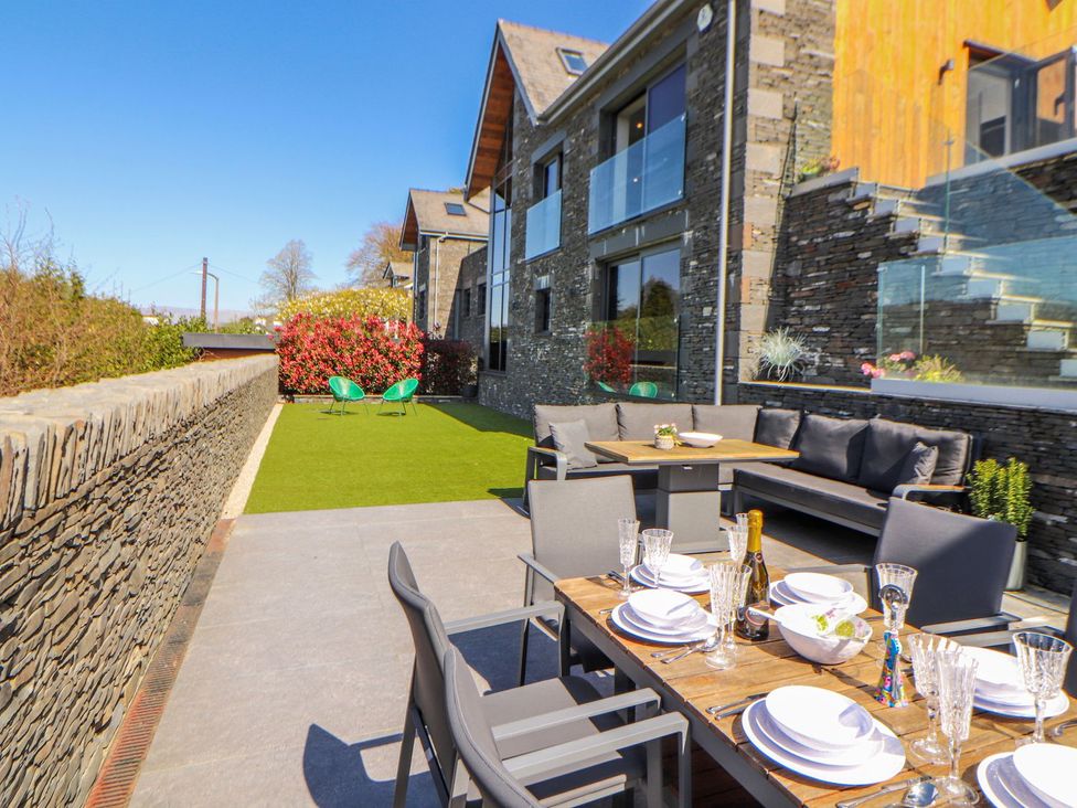 An outdoor dining area with a table and chairs at Midways in Windermere