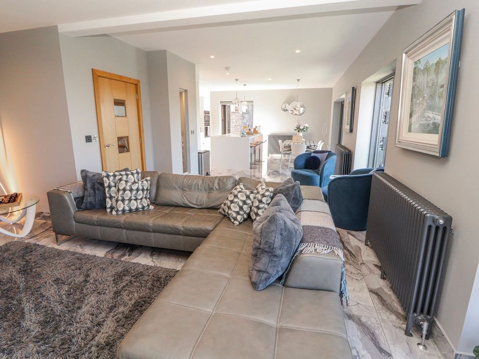 A living room with a sofa and rug at Midways in Windermere