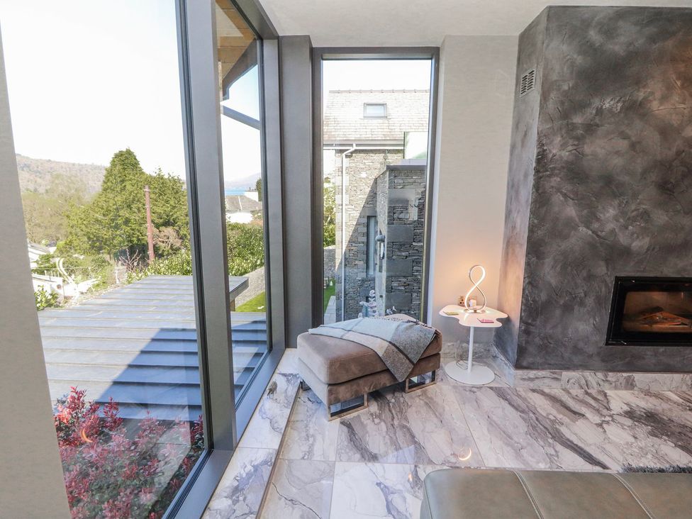 A living room with a view and a fireplace at Midways in Windermere