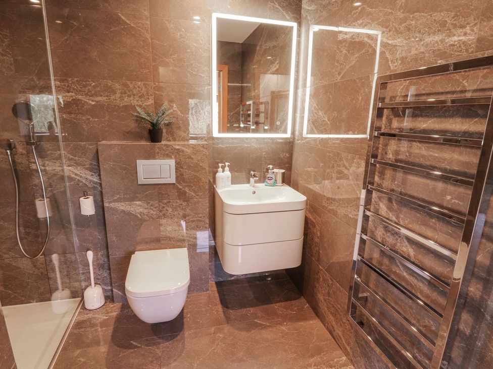 A bathroom with a shower and sink at Midways in Windermere