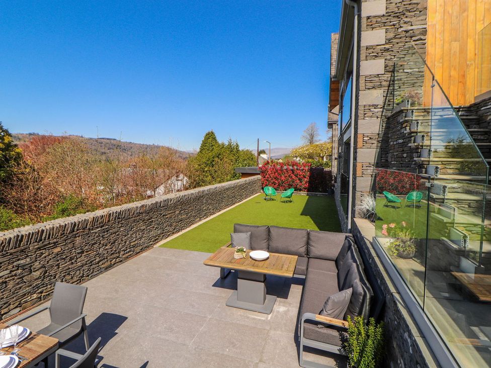 An outdoor area with a couch and table at Midways in Windermere
