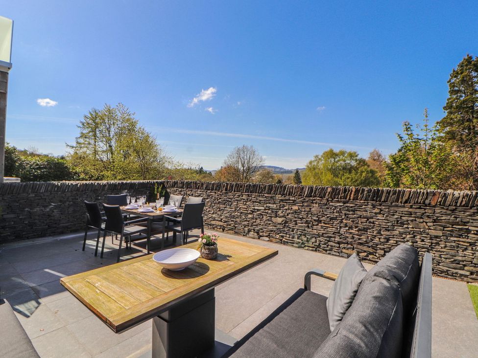 An outdoor seating area with a table and chairs at Midways in Windermere