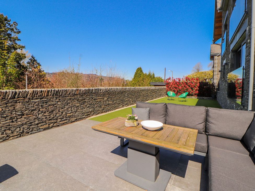 An outdoor seating area with a table and couch at Midways in Windermere